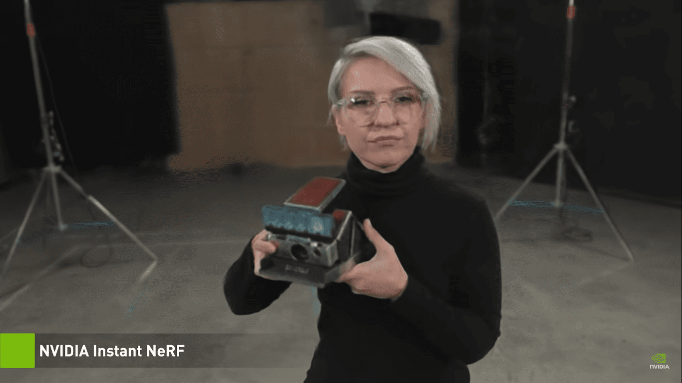 model dressed like Andy Warhol with black turtle neck shirt holding a polaroid camera