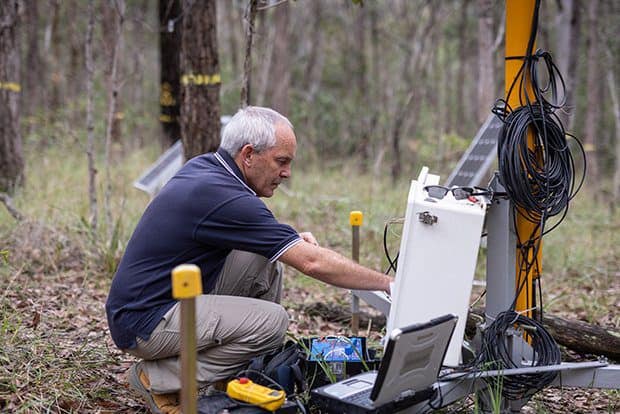 Professor Hamish McGowan testing apparatus in the woods