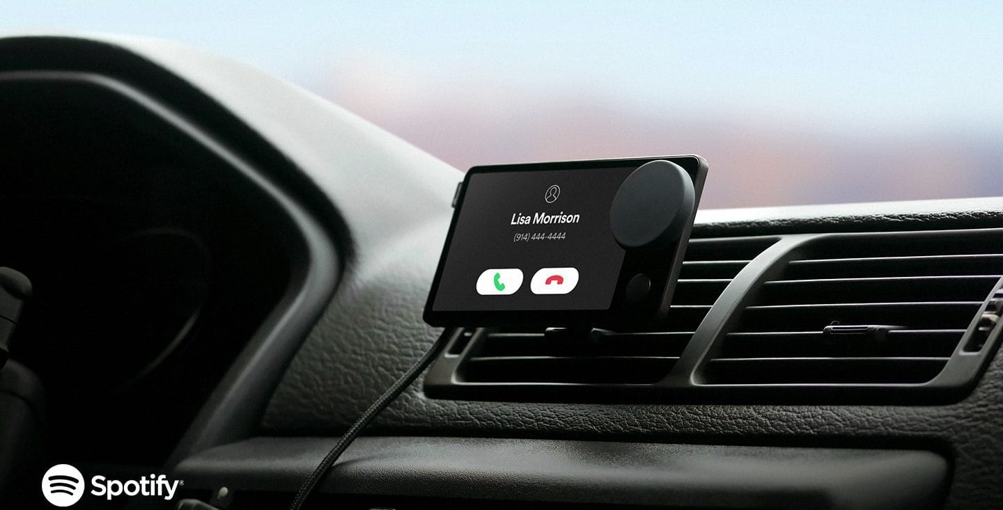 Spotipy Car thing attached on car's black airconditioner blade while showing incoming call