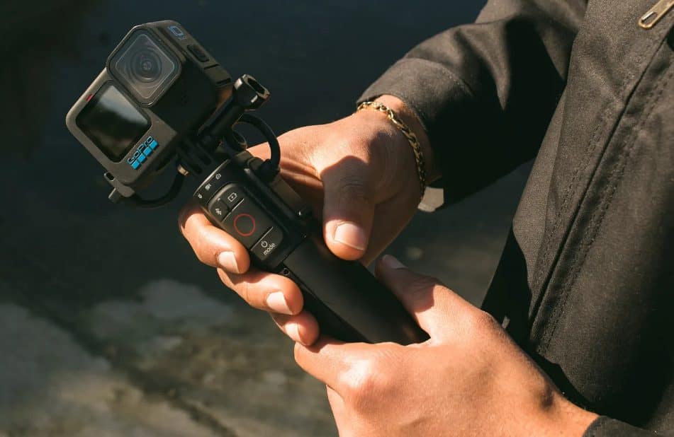 hands holding Volta Battery and Remote Control Grip with a GoPro camera attached