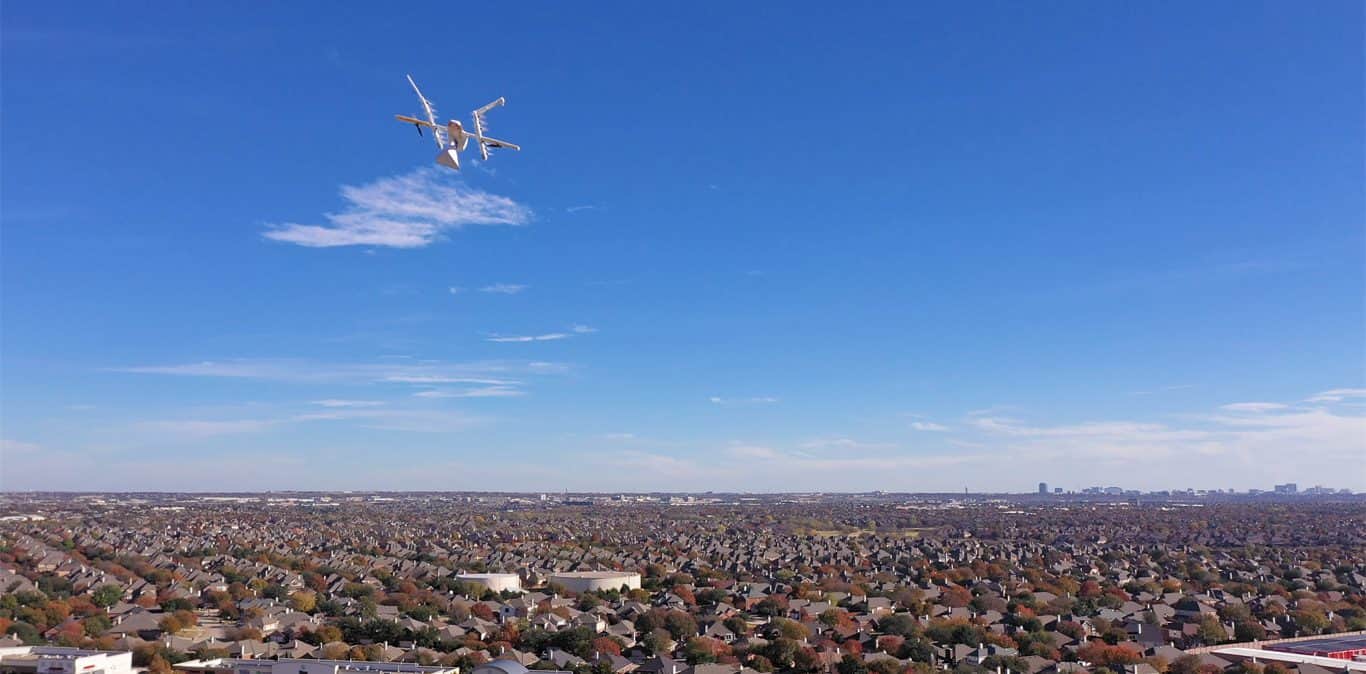 Wing drone airborne while delivering a package