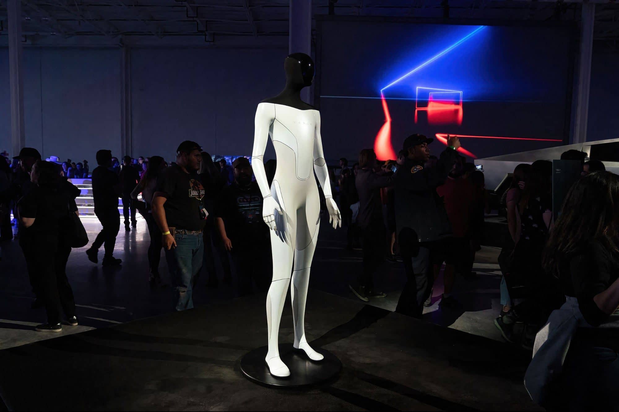 The Tesla Optimus robot on display at the Tesla Giga Texas manufacturing facility with spectators around