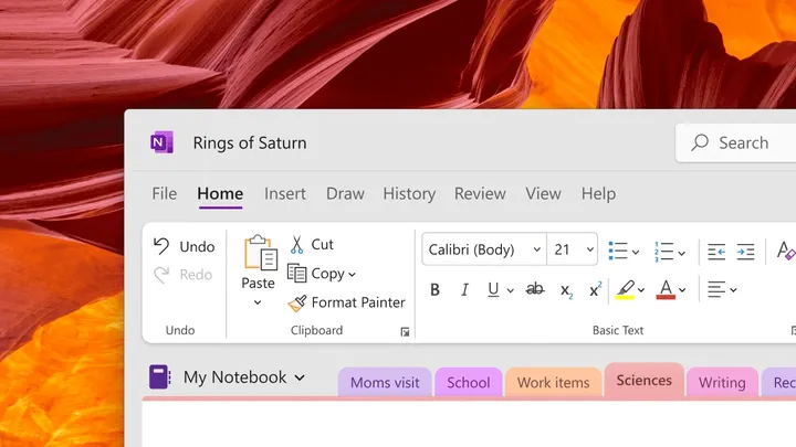 new OneNote design in front of Windows 11 desktop wallpaper