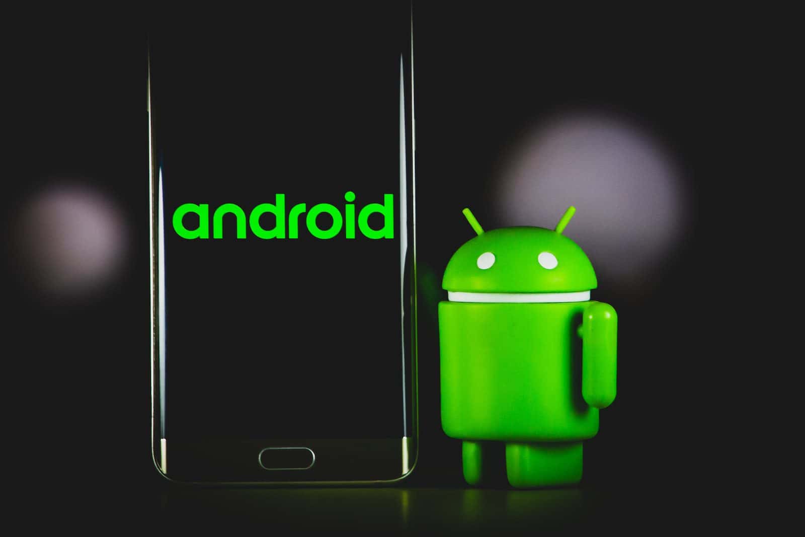 zelená žába pouzdro na iphone vedle černého smartphonu samsung android