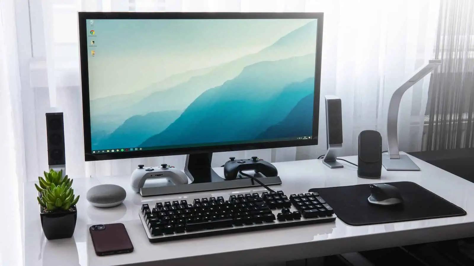 black computer keyboard beside silver imac